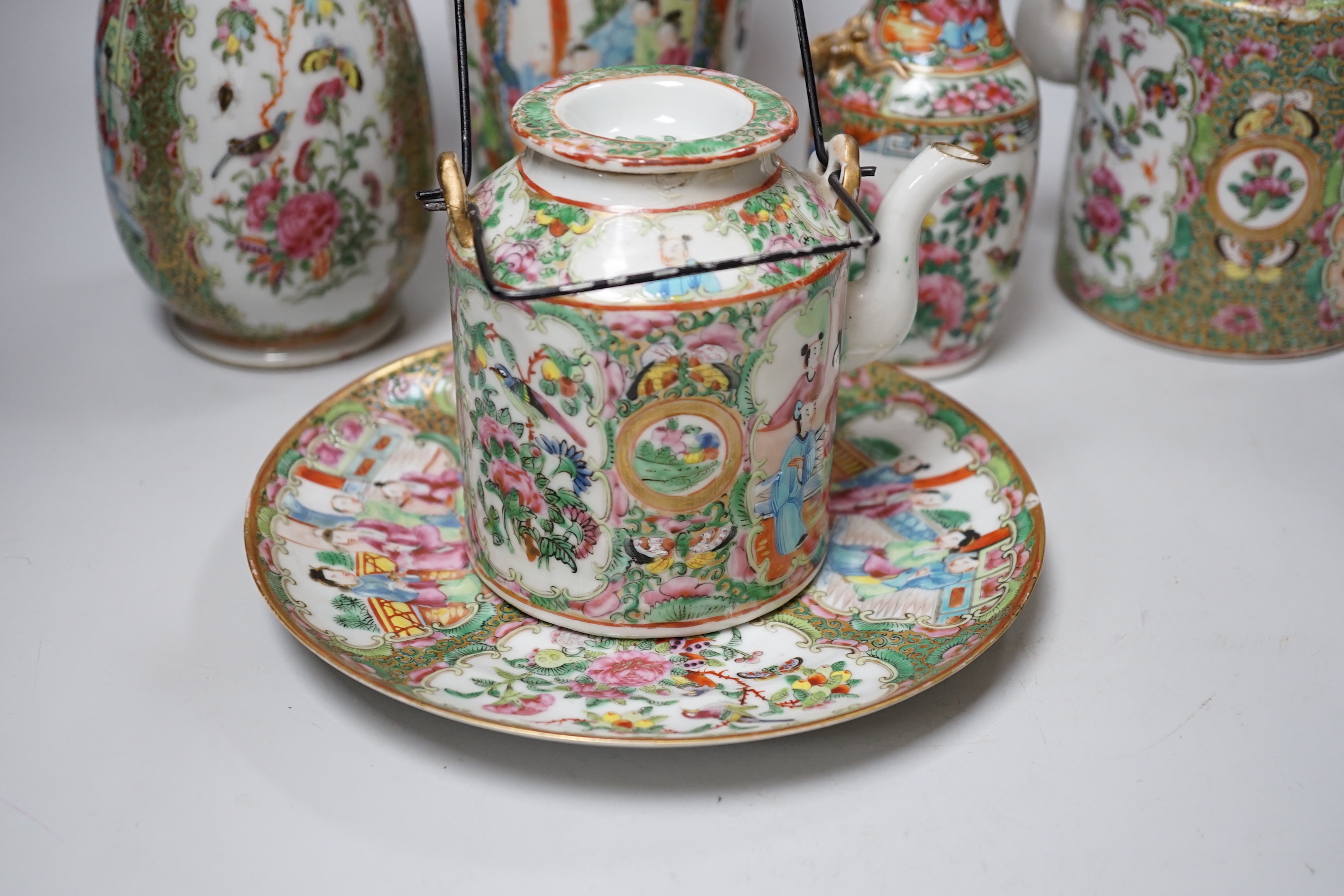 A collection of Chinese Cantonese famille rose vases, two teapots and a plate